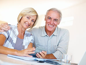 Smiling couple reviewing estate documents. Link to Tangible Personal Property Smiling couple reviewing estate documents. Link to Tangible Personal Property