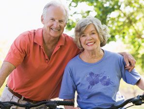 Photo of a man and woman on bicycles. Link to Life Stage Gift Planner Ages 60-70 Situations.